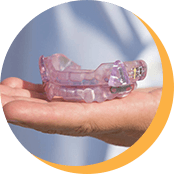 Hand holding sleep apnea appliance